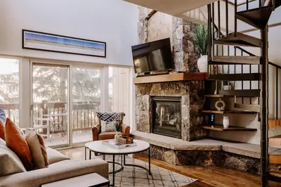 a living room with a fireplace and a tv at Alpine Hideaway with Free Shuttle - Wildernest in Silverthorne