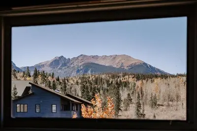 a house in the foreground with a mountain in the background at Alpine Hideaway with Free Shuttle - Wildernest in Silverthorne