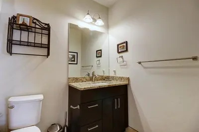 a bathroom with a toilet and a sink and a mirror at Sail Lofts 101 condo in Dillon