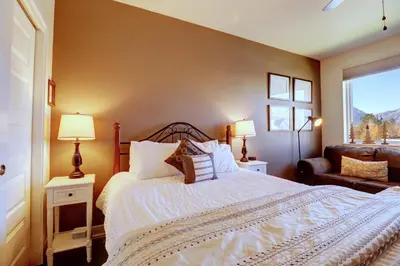 a bedroom with a bed and a couch and a window at Sail Lofts 101 condo in Dillon