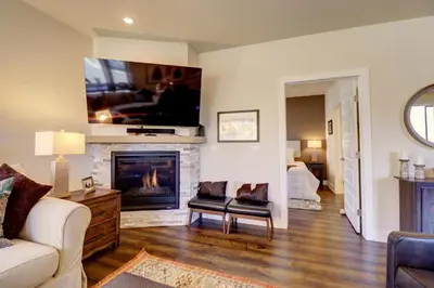 a living room with a fireplace and a tv on the wall at Sail Lofts 101 condo in Dillon