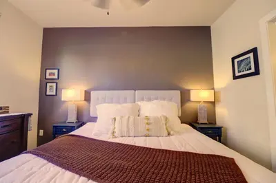 a bedroom with a large white bed with two lamps at Sail Lofts 101 condo in Dillon