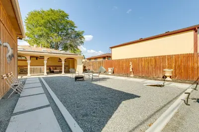 a yard with chairs and a fence and a building at 6 Mi to Dtwn Denver Escape with Fire Pit in Denver