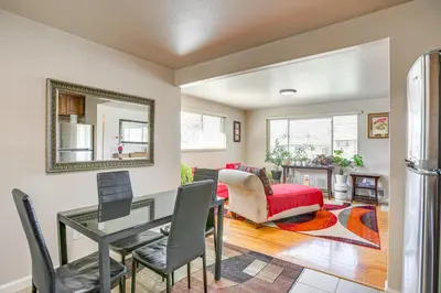 a living room with a table and chairs and a mirror at 6 Mi to Dtwn Denver Escape with Fire Pit in Denver
