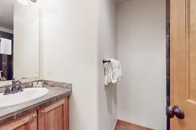 a bathroom with a sink and a mirror at Rendezvous Royalty in Fraser