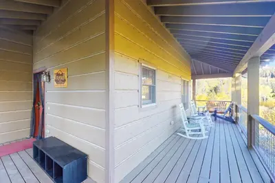 a porch of a house with a bench on it at Rendezvous Royalty in Fraser