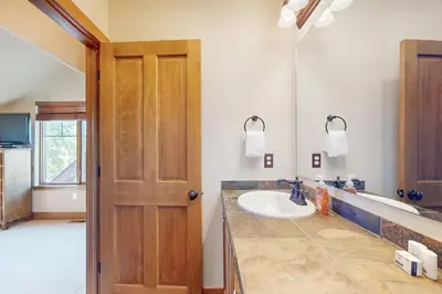 a bathroom with a sink and a mirror at Rendezvous Royalty in Fraser