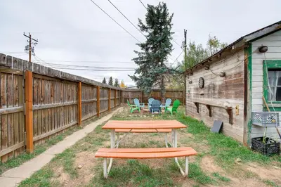 a picnic table in a yard next to a fence at Hike, Ski and More Walkable Downtown Granby Home in Granby