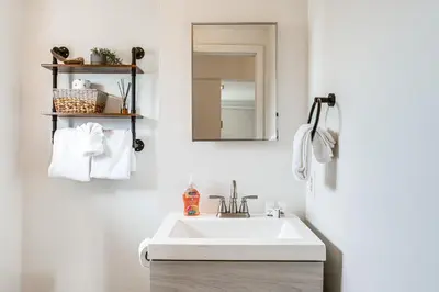 a bathroom with a sink and a mirror at Hike, Ski and More Walkable Downtown Granby Home in Granby