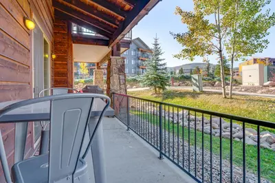 a balcony with a railing with a view of a yard at Downtown WP Condo with Pool Steps to Concert Venue! in Winter Park