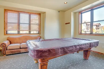 a living room with a couch and a table at Downtown WP Condo with Pool Steps to Concert Venue! in Winter Park