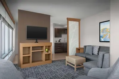 a living room with a couch and a tv at Hyatt Place Boulder Pearl Street - Newly Renovated in Boulder