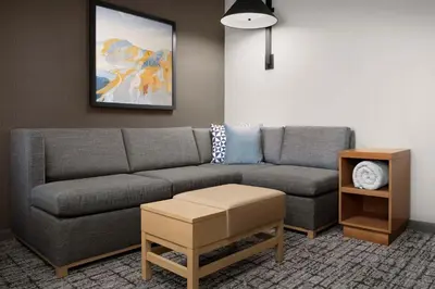 a living room with a couch and a table at Hyatt Place Boulder Pearl Street - Newly Renovated in Boulder