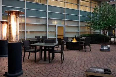 a patio with tables and chairs in front of a building at Hyatt Place Boulder Pearl Street - Newly Renovated in Boulder