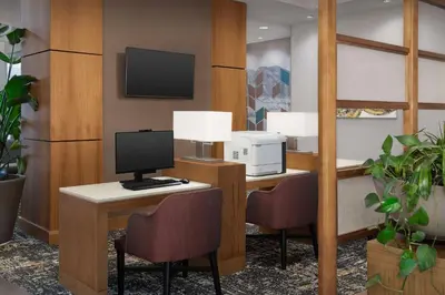 an office with a desk with a computer and two chairs at Hyatt Place Boulder Pearl Street - Newly Renovated in Boulder