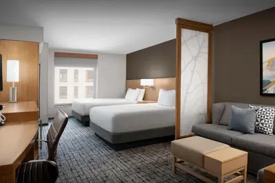 a hotel room with two beds and a couch at Hyatt Place Boulder Pearl Street - Newly Renovated in Boulder