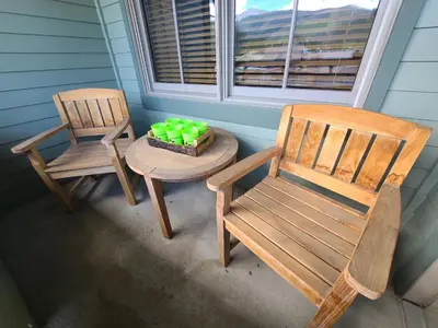 two chairs and a table with a cake on a porch at Ski-In Ski-Out Condo at Zephyr Mountain Lodge 1518 in Winter Park
