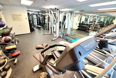 a gym with a lot of treadmills and machines at Ski-In Ski-Out Condo at Zephyr Mountain Lodge 1518 in Winter Park