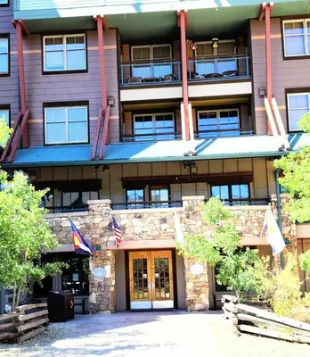 a building with flags in front of it at Ski-In Ski-Out Condo at Zephyr Mountain Lodge 1518 in Winter Park