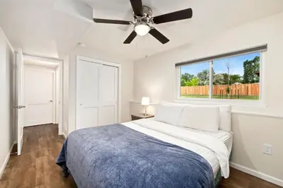 a bedroom with a bed and a ceiling fan at RMNP Retreat Group Friendly Home near Estes Park in Loveland