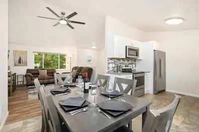 a dining room and living room with a table and chairs at RMNP Retreat Group Friendly Home near Estes Park in Loveland