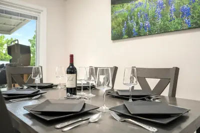 a table with a bottle of wine and glasses on it at RMNP Retreat Group Friendly Home near Estes Park in Loveland