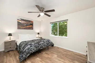 a bedroom with a bed and a ceiling fan at RMNP Retreat Group Friendly Home near Estes Park in Loveland