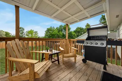 a patio with a stove and chairs on a deck at RMNP Retreat Group Friendly Home near Estes Park in Loveland