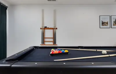 a black pool table with billiard balls and chopsticks at Spacious and Cozy 5 Bed 3 Bath Vacation House W 2 King 3 Queen! Sleep 12! 15Min to Red Rocks in Arvada