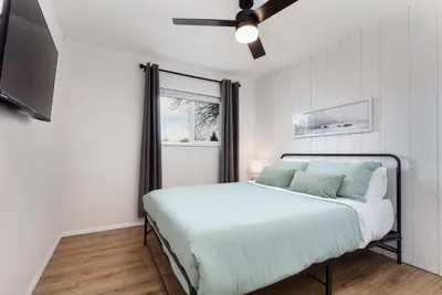a bedroom with a bed and a ceiling fan at Spacious and Cozy 5 Bed 3 Bath Vacation House W 2 King 3 Queen! Sleep 12! 15Min to Red Rocks in Arvada