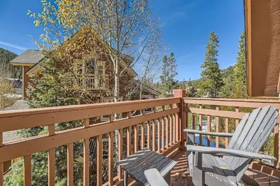 a wooden deck with a chair and a house at 6507 Settlers Creek Townhomes townhouse in Keystone