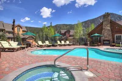 a pool at a resort with a mountain in the background at 6507 Settlers Creek Townhomes townhouse in Keystone