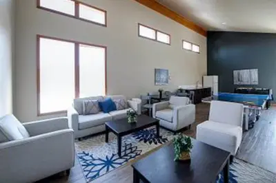 a living room with a couch and chairs and a table at Snowscape Modern Mountain Retreat in Silverthorne