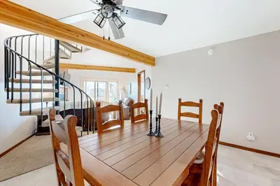 a dining room with a table and a ceiling fan at Snowscape Modern Mountain Retreat in Silverthorne