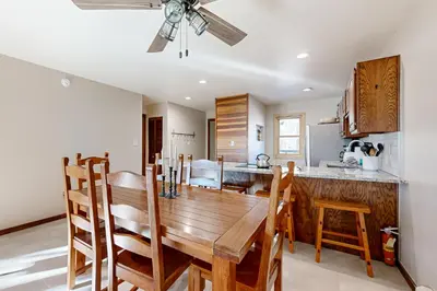 a kitchen and dining room with a wooden table and chairs at Snowscape Modern Mountain Retreat in Silverthorne
