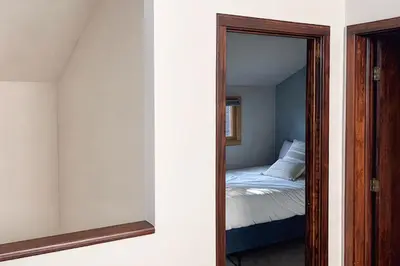 a mirror in a room with a bed and a bedroom at Snowscape Modern Mountain Retreat in Silverthorne