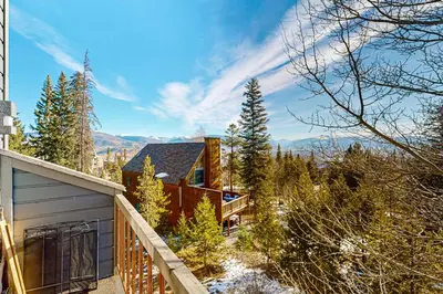 a house on a hill with a balcony at Snowscape Modern Mountain Retreat in Silverthorne