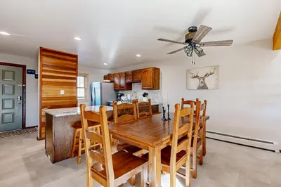 a dining room with a wooden table and chairs at Snowscape Modern Mountain Retreat in Silverthorne