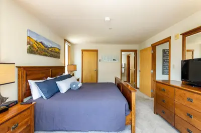 a bedroom with a bed and a television at 1483 Lakeside condo in Keystone