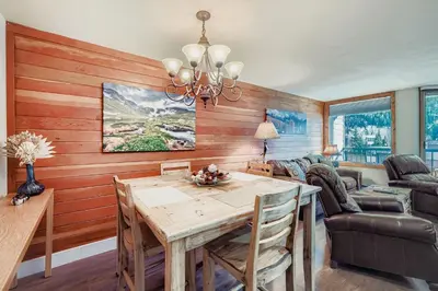 a dining room with a table and a couch at 1483 Lakeside condo in Keystone