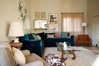 a living room with a blue couch and a table at Mountain cabin w game room & hot tub in Bailey