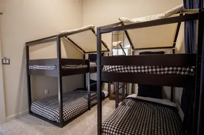 a room with two bunk beds in a room at Mountain cabin w game room & hot tub in Bailey
