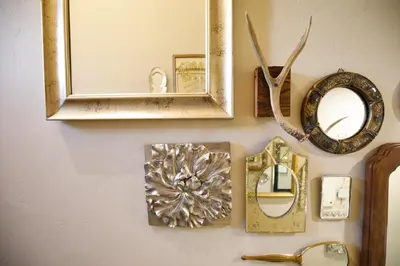 a mirror and some framed items on a wall at Mountain cabin w game room & hot tub in Bailey
