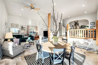 a living room with a table and chairs at Mountain cabin w game room & hot tub in Bailey