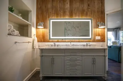 a bathroom with a sink and a mirror at Mountain cabin w game room & hot tub in Bailey