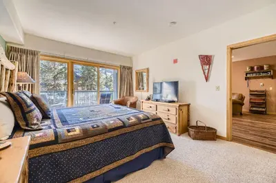 a bedroom with a large bed and a television at 5023 Gateway condo in Keystone