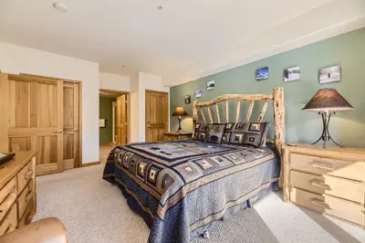 a bedroom with a wooden bed and a dresser at 5023 Gateway condo in Keystone