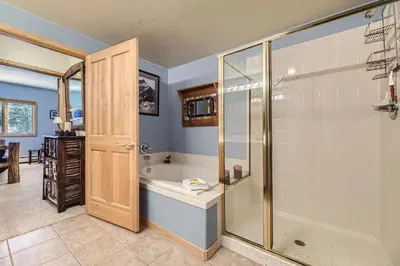 a bathroom with a tub and a shower stall at 5023 Gateway condo in Keystone