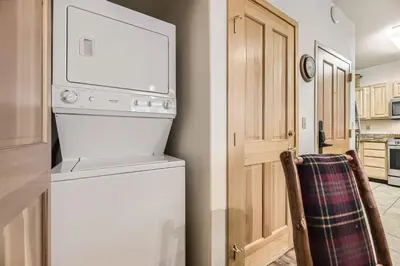 a kitchen with a washer and dryer in a room at 5023 Gateway condo in Keystone