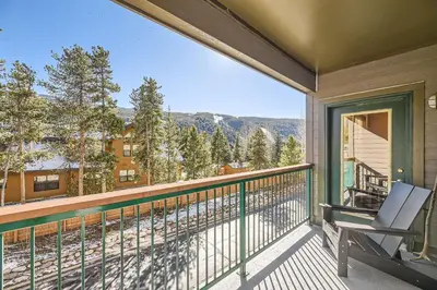 a balcony with a chair and a view of the mountains at 5023 Gateway condo in Keystone